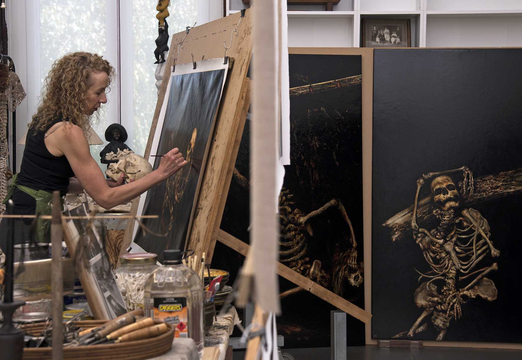 Terry Taylor in her studio painting one of her artwork