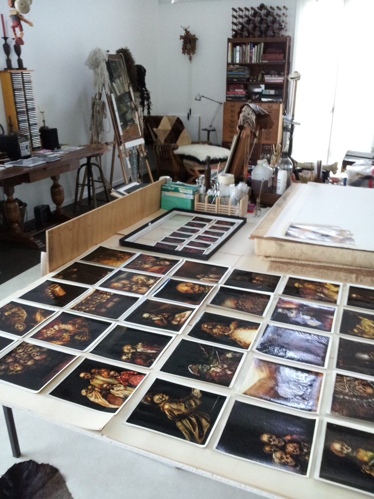 Photographs of Terry Taylor's artwork on table in her studio